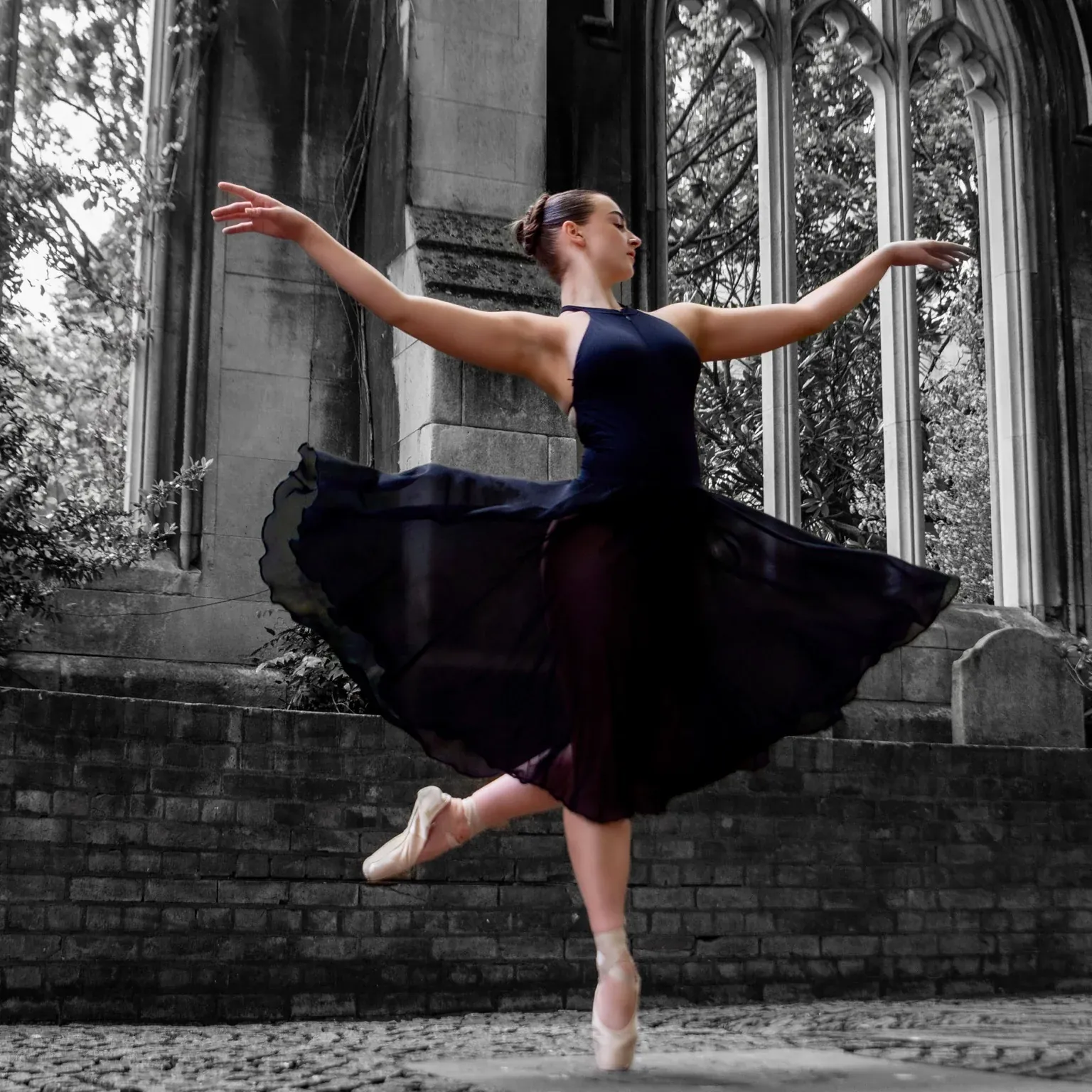 Ballet dancer framed by gothic arches