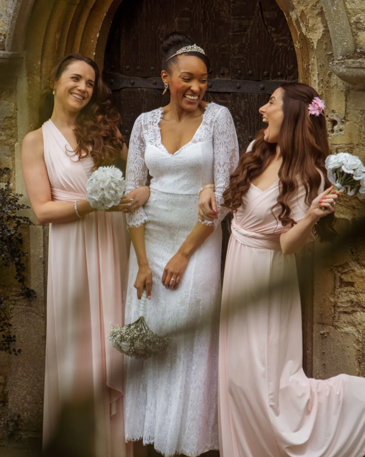 Bride laughing with bridesmaids